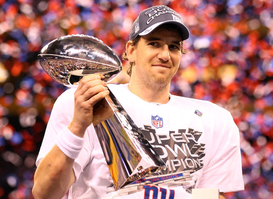 Eli Manning #10 of the New York Giants hoist the Vince Lombardi Trophy after defeating the New England Patriots in Super Bowl XLVI at Lucas Oil Stadium on February 5, 2012 in Indianapolis, Indiana. The New York Giants defeated the New England Patriots 21-17. (Photo by Al Bello/Getty Images)