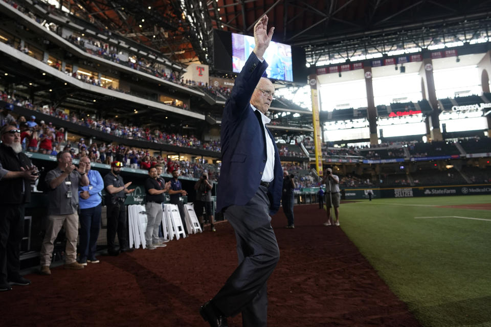 Baseball great and former Texas Rangers pitcher Nolan Ryan waves to the crowd as he takes the field for a screening of a documentary film about him, after a baseball ball game between the Atlanta Braves and Texas Rangers in Arlington, Texas, Sunday, May 1, 2022. (AP Photo/LM Otero)