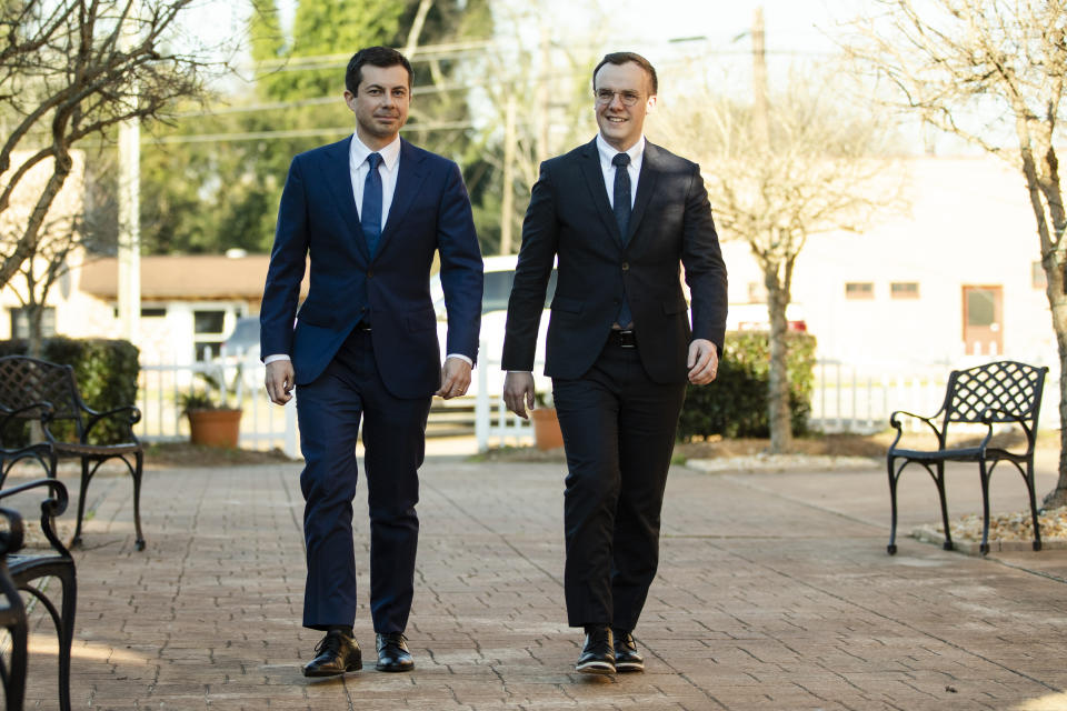 Democratic presidential candidate and former South Bend, Ind. Mayor Pete Buttigieg, left, accompanied by his husband Chasten Buttigieg, walk to speaks with members of the media, Sunday, March 1, 2020, in Plains, Ga. (AP Photo/Matt Rourke)