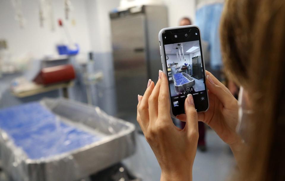 A Ukrainian doctor snaps a photo of the tub room during a tour of the burn center at Akron Children's Hospital on Wednesday.