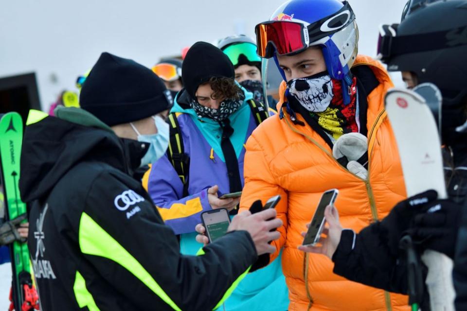 People show their <span>EU Digital COVID Certificate</span> (<span>Green Pass</span>) in order to use the ski lifts as ski resorts reopen for winter despite the fear over a rise in coronavirus disease (COVID-19) infections, in Madonna di Campiglio, northern Italy, November 20, 2021. REUTERS/Flavio Lo Scalzo