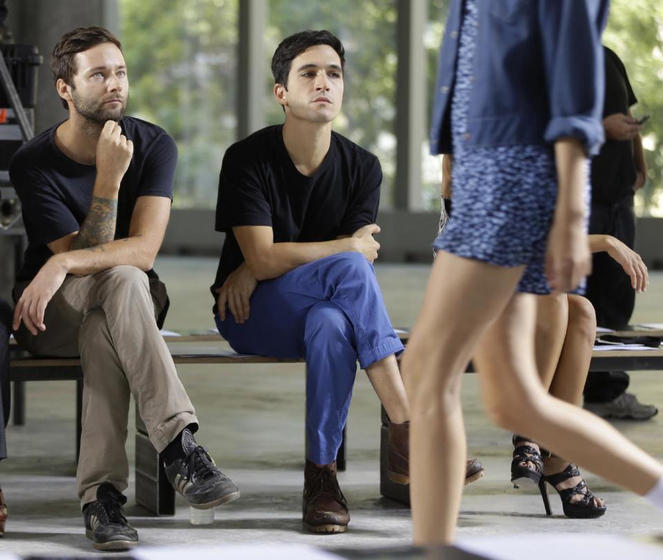 Proenza Schouler designers Jack McCollough, left, and Lazaro Hernandez watch a run-through before their Spring 2014 collection is modeled during Fashion Week in New York, Wednesday, Sept. 11, 2013. (AP Photo/Seth Wenig)