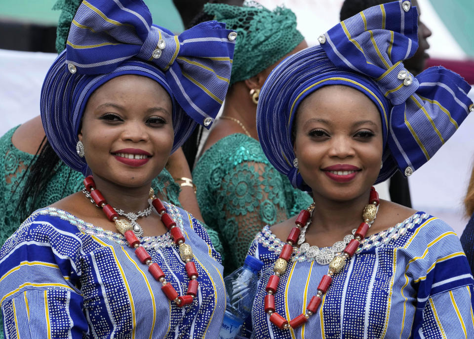 Twins Obasekore Damilade, left, Obasekore Damitola, 28, attend the annual twins festival in Igbo-Ora South west Nigeria, Saturday, Oct. 8, 2022. The town holds the annual festival to celebrate the high number of twins and multiple births. (AP Photo/Sunday Alamba)