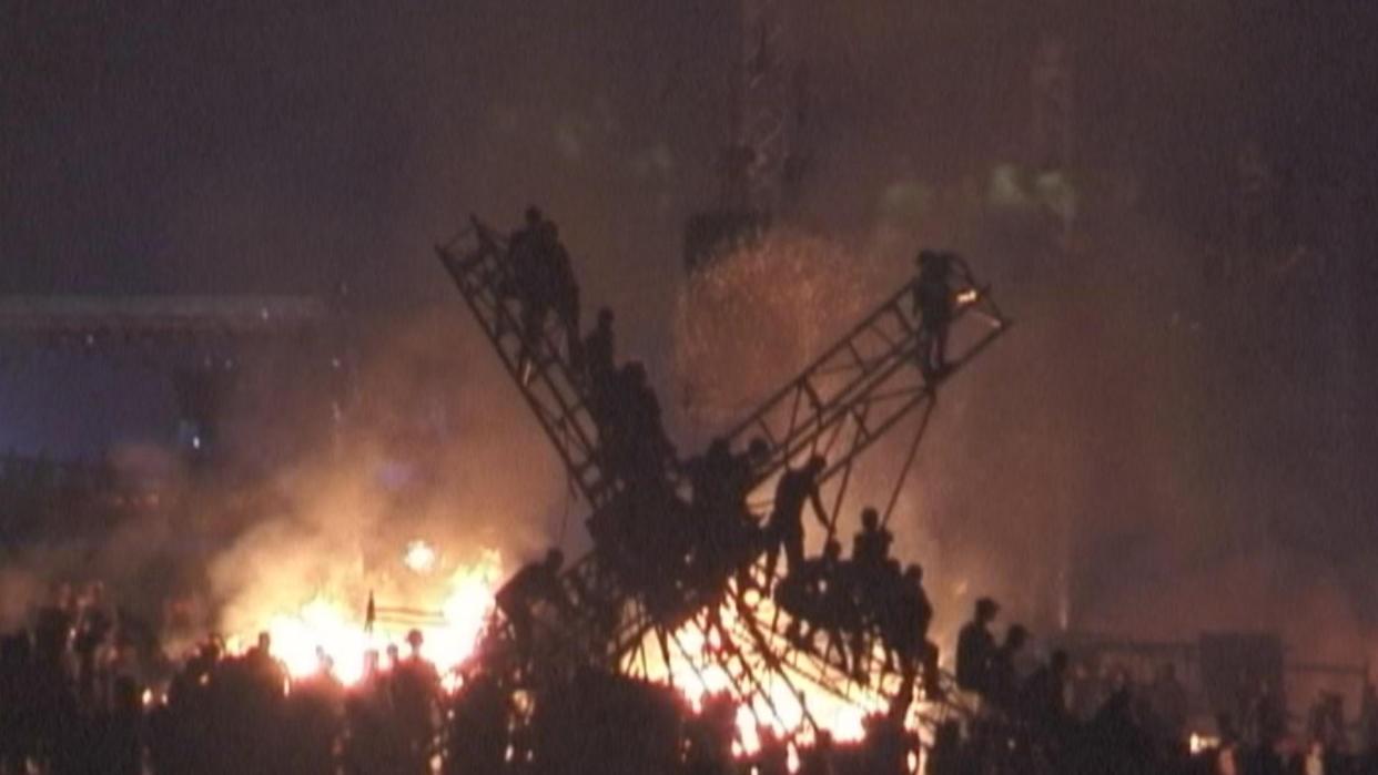 A fire rages as Woodstock '99 comes to a close in July 1999. A new docuseries looks at everything that went wrong.