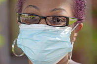 Parent and teacher Stacey Pugh poses for a photograph outside her home Monday, July 13, 2020, in Humble, Texas. While children have proven to be less susceptible to the coronavirus, teachers are vulnerable. “I will be wearing a mask, a face shield, possibly gloves, and I’m even considering getting some type of body covering to wear,” says Pugh, a fifth-grade teacher in suburban Houston. (AP Photo/David J. Phillip)