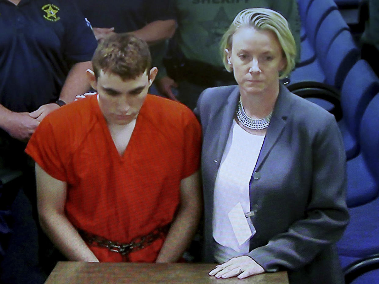 A video monitor shows school shooting suspect Nikolas Cruz making an appearance in Broward County Court: Susan Stocker/South Florida Sun-Sentinel via AP