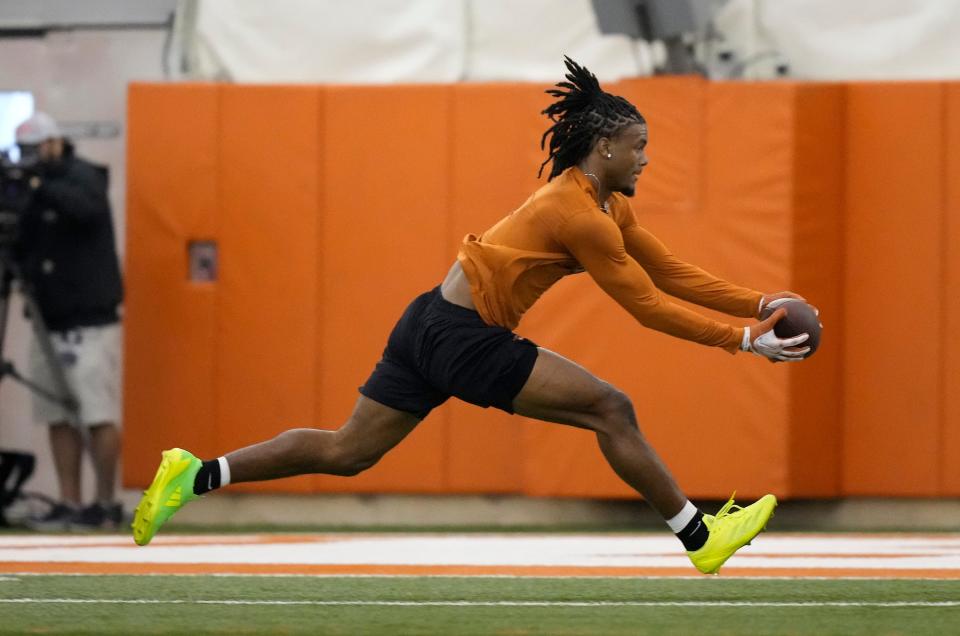 Wide receiver Adonai Mitchell snags a pass during Wednesday's UT pro timing day inside the practice bubble at Denius Fields. Mitchell, along with fellow Texas receivers Xavier Worthy and Jordan Whittington, is prepping for next month's NFL draft.