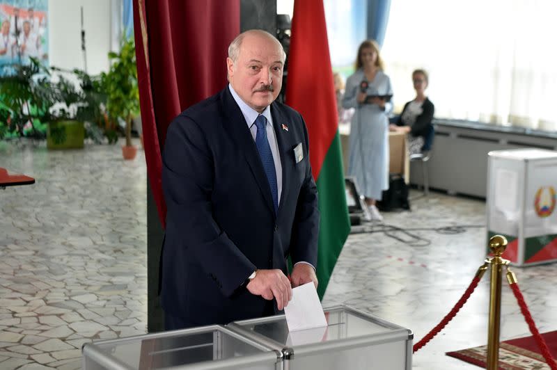 Belarusian President Alexander Lukashenko casts his ballot at a polling station during the presidential election in Minsk