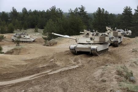 U.S. soldiers of the 2nd Battalion, 7th Infantry Regiment, "Cottonbalers", who are deployed in Latvia, take part in a training exercise with M1A2 "Abrams" tanks in Adazi military base, Latvia, May 7, 2015. REUTERS/Ints Kalnins