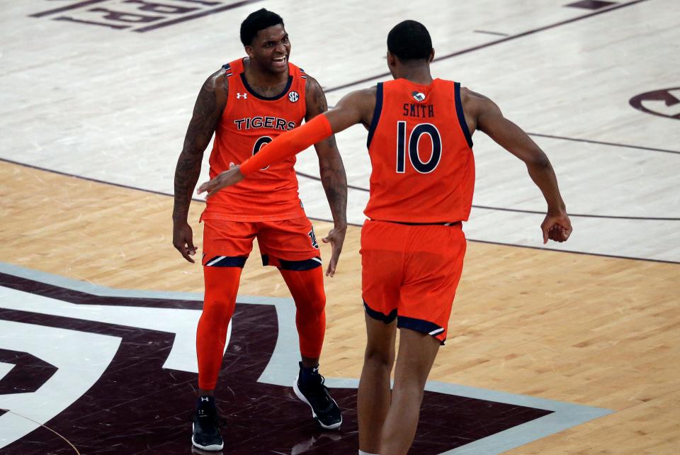 Auburn guard K.D. Johnson (0) reacts with forward Jabari Smith (10) after a basket against the Mississippi State Bulldogs in overtime at Humphrey Coliseum.