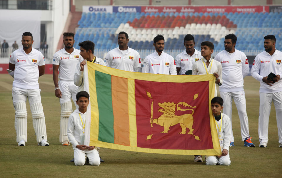 Sri Lankan players stand for the national anthem before the start of the first cricket test match between Pakistan and Sri Lanka in Rawalpindi, Pakistan, Wednesday, Dec. 11, 2019. (AP Photo/Anjum Naveed)