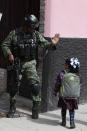 In this Feb. 12, 2020 photo, a soldier on patrol greets a child walking home from school with her mother, in Irapuato, Guanajuato state, Mexico. Most investors - and even local officials - seem prepared to ignore the murder wave as gang members kill gang members. “There are victims who are caught in the crossfire, and they are the ones I really feel sorry for," said Mayor Ricardo Ortiz. "But we can’t be expected to protect people who are doing bad things.” (AP Photo/Rebecca Blackwell)