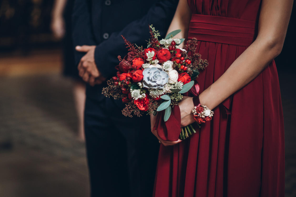 bridesmaid holding rustic bouquet with groomsman,  couple in church during wedding ceremony, religion traditions