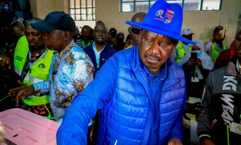 Opposition leader and candidate Raila Odinga waves to supporters after casting his vote in Nairobi