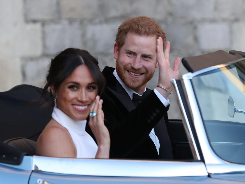 Meghan Markle and Prince Harry on their way to their wedding reception in 2018. Meghan wears Princess Diana's aquamarine ring