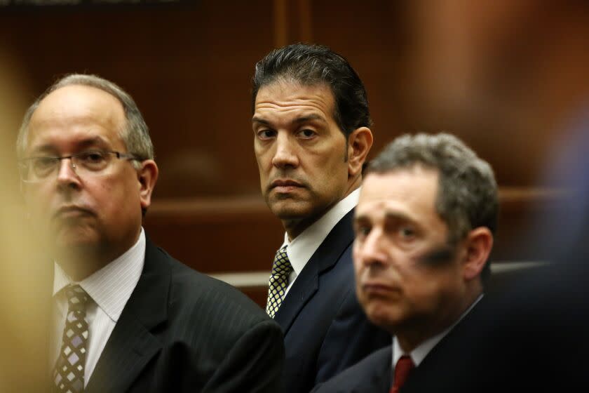 LOS ANGELES, CA - APRIL 23, 2013: Los Angeles County Assessor John Noguez and principal assessor Mark McNeil and tax consultant Ramin Salari with their attorneys appear before the court in Los Angeles. Prosecutors have charged Noguez with 11 additional counts of misappropriating public funds by allegedly lowering property tax bills for campaign contributors. Prosecutors dropped five earlier charges against him, leaving him facing a total of 30 criminal counts. Prosecutors have also filed more than three dozen additional charges against Noguez's co-defendant, tax consultant Ramin Salari, and 11 new counts against principal assessor Mark McNeil. The three defendants have pleaded not guilty to the new charges. (Irfan Khan / Los Angeles Times)