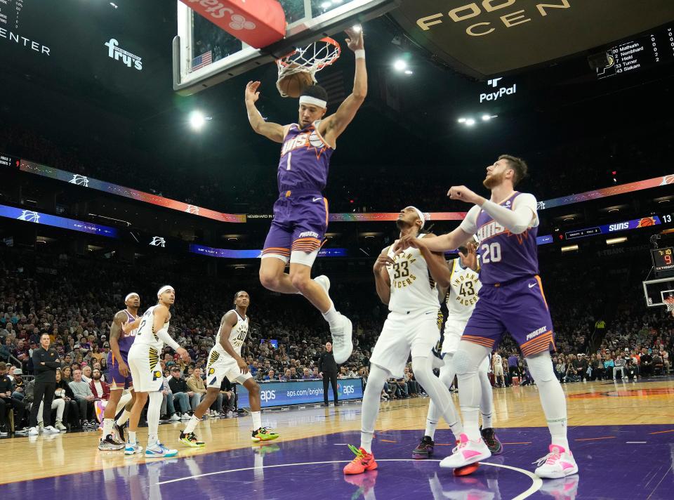 Phoenix Suns guard Devin Booker (1) slams two against the Indiana Pacers during the first quarter at Footprint Center in Phoenix on Jan. 21, 2024.
