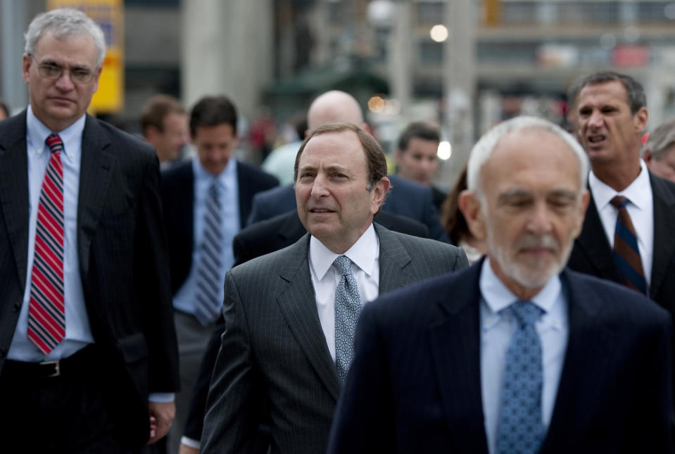 NHL commissioner Gary Bettman, center, arrives with members of his negotiating team for collective bargaining talks in Toronto on Tuesday, Aug. 14, 2012. Negotiations continue between the league and the NHLPA to avoid a potential lockout. (AP Photo/The Canadian Press, Chris Young)