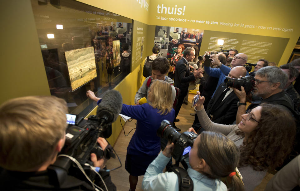 FILE - In this Tuesday, March 21, 2017 file photo, media take images of two stolen and recovered paintings by Dutch master Vincent van Gogh during a press conference in Amsterdam, Netherlands. Two paintings by Vincent van Gogh went back on display in Amsterdam in 2017, more than 14 years after thieves ripped them off the walls of the Van Gogh Museum during a audacious nighttime raid. A brazen burglary on Monday Nov. 25, 2019 from Dresden’s Green Vault, one of the world’s oldest museums, holding priceless treasures is another in a long history of daring European heists over the years. (AP Photo/Peter Dejong, File)