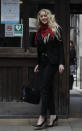 Actress Amber Heard, center, arrives at the High Court in London, Thursday, July 16, 2020. Actor Johnny Depp is suing News Group Newspapers, publisher of The Sun, and the paper’s executive editor, Dan Wootton, over an April 2018 article that called him a “wife-beater.” The Sun’s defense relies on a total of 14 allegations by Heard of Depp’s violence. He strongly denies all of them. (AP Photo/Alastair Grant)