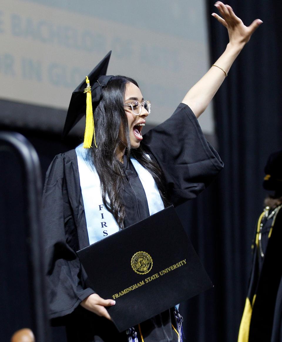 Framingham State University graduate Skye Monteiro gives a shout-out to friends and family after receiving her diploma, May 21, 2023.