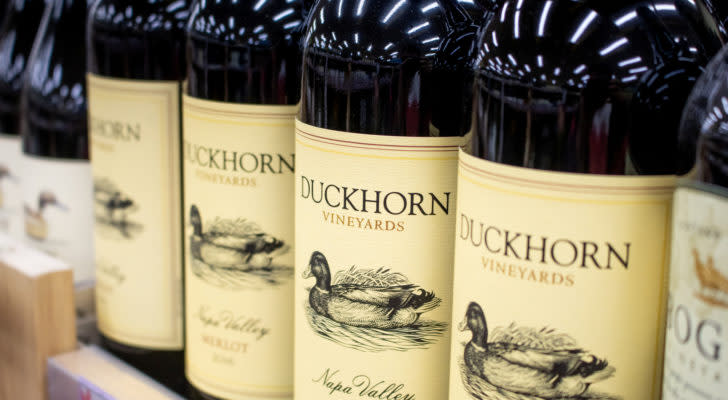 Several bottles of Duckhorn Vineyards merlot are lined up in a row.