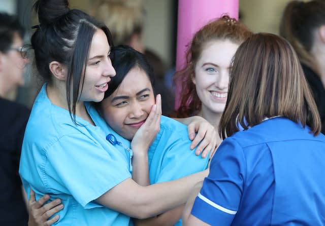 NHS staff from Aintree University Hospital in Liverpool react during the applause