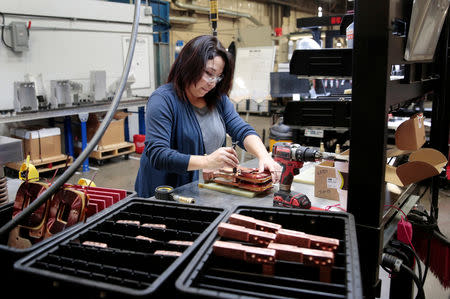 Assembly product worker Donna Gonzalez works on a sub-assembly to a water cooled transformer at RoMan Manufacturing in Grand Rapids, Michigan, U.S. December 12, 2018. Picture taken December 12, 2018. REUTERS/Rebecca Cook