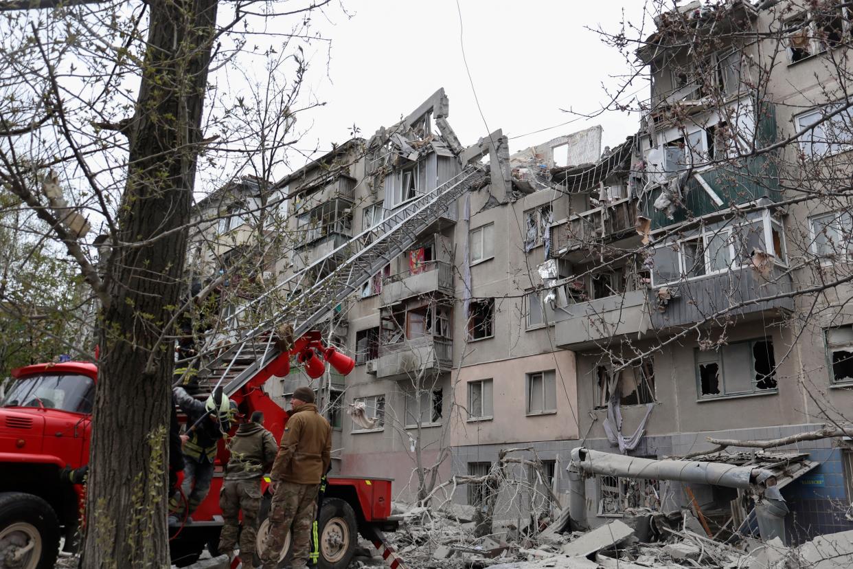 Firefighters work to extinguish a fire as they look for potential victims after today Russian rocket attack in Sloviansk, Donetsk region, Ukraine (AP)