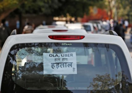 FILE PHOTO: A note is pasted on a rear window of a car during a protest by Uber and Ola drivers, in New Delhi, India, February 14, 2017. The note reads “Ola and Uber it is Strike”. REUTERS/Adnan Abidi