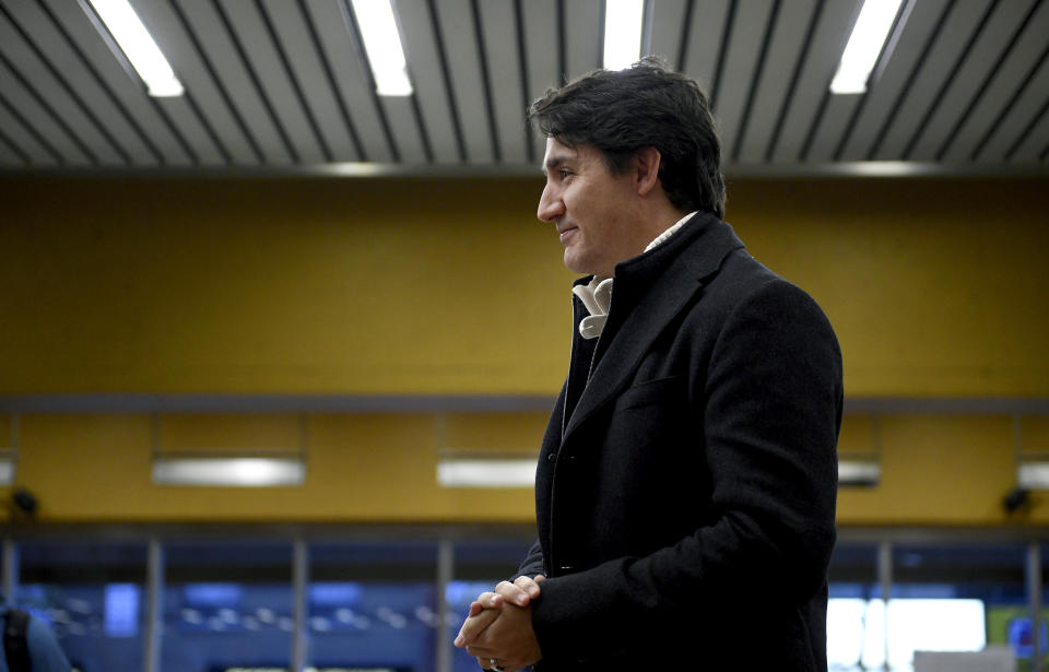 Canada's Prime Minister Justin Trudeau greets commuters at a metro station in Montreal, Tuesday, Oct. 22, 2019. Trudeau won a second term in Canada's national elections Monday, losing the majority but delivering unexpectedly strong results despite having been weakened by a series of scandals that tarnished his image as a liberal icon. (Sean Kilpatrick/The Canadian Press via AP)