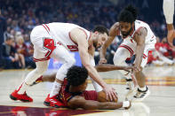 Cleveland Cavaliers' Collin Sexton, bottom, battles Chicago Bulls' Zach LaVine, left, and Coby White, right, for the ball in the first half of an NBA basketball game, Saturday, Jan. 25, 2020, in Cleveland. (AP Photo/Ron Schwane)