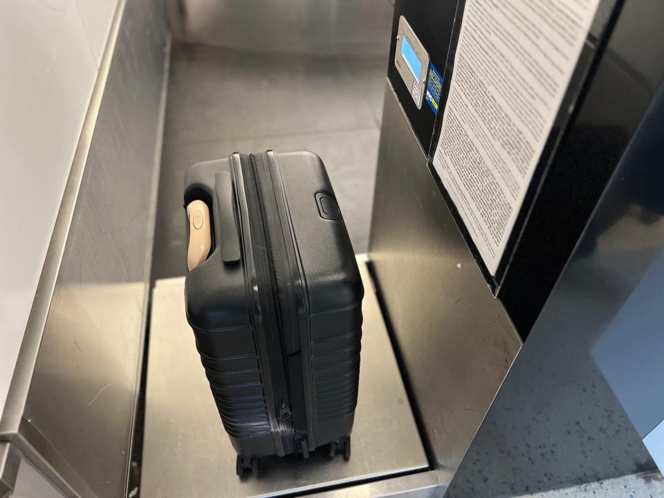 The author's luggage placed on a set of scales at baggage check in.