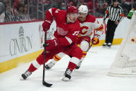 Detroit Red Wings left wing Adam Erne (73) looks to pass as Calgary Flames defenseman Rasmus Andersson (4) defends in the second period of an NHL hockey game Thursday, Oct. 21, 2021, in Detroit. (AP Photo/Paul Sancya)