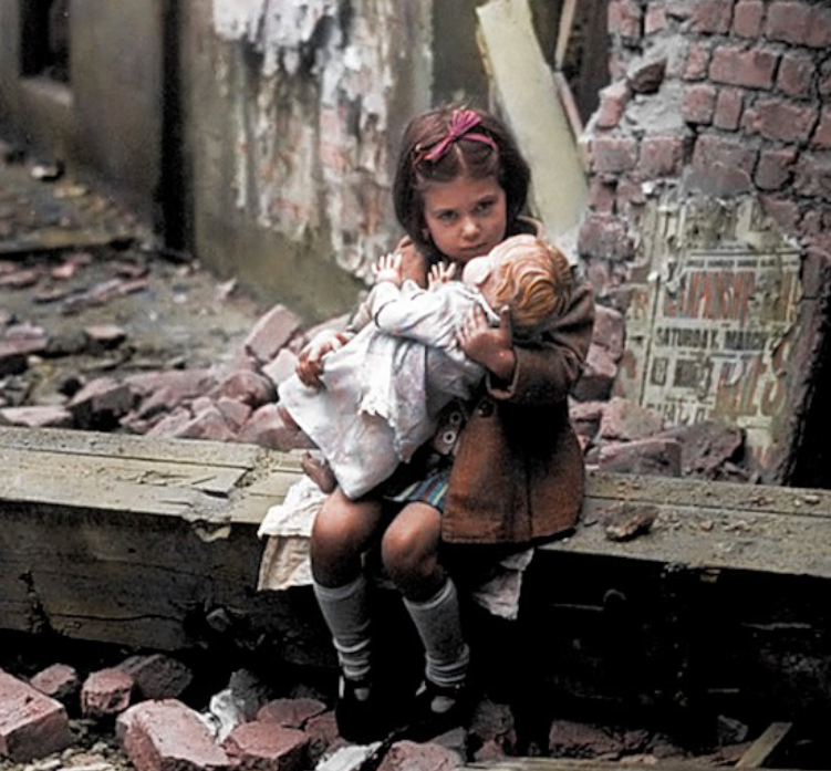 <p>A little girl was pictured cradling her doll amongst the rubble following another German bombing. (MediaDrumWorld) </p>