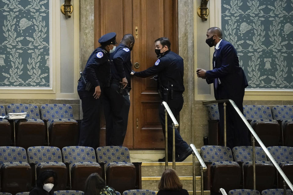 FILE - In this Jan. 6, 2021, photo U.S. Capitol Police secure a door as rioters try to break into the House Chamber at the U.S. Capitol in Washington. (AP Photo/J. Scott Applewhite, File)