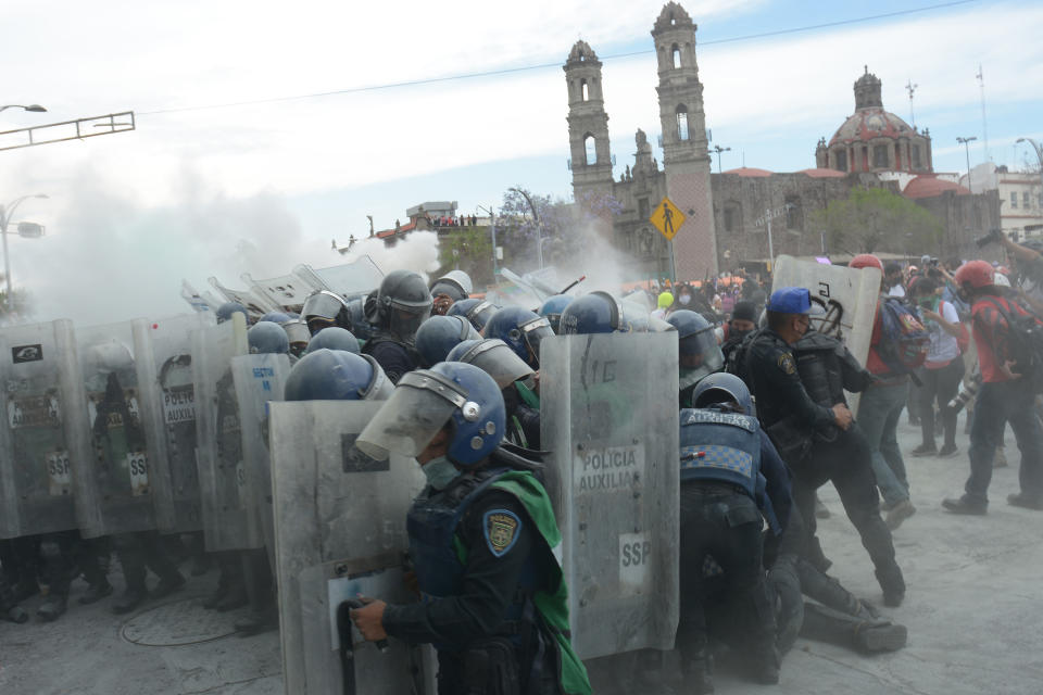 MEXICO CITY, MEXICO - MARCH 08: Women clash with riot police officers during International Women´s Day protest on March 8, 2021 in Mexico City, Mexico. (Photo by Medios y Media/Getty Images)