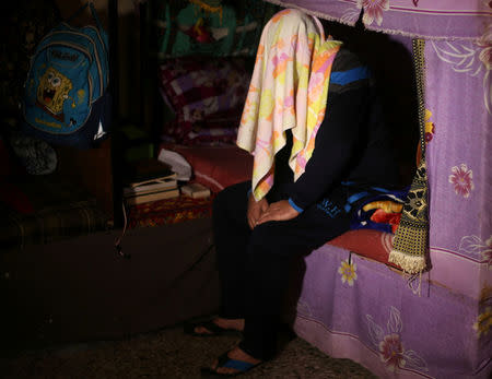 A drug dealer has his face covered with a towel during an interview with Reuters at a Hamas-run prison in Gaza City March 1, 2017. REUTERS/Mohammed Salem