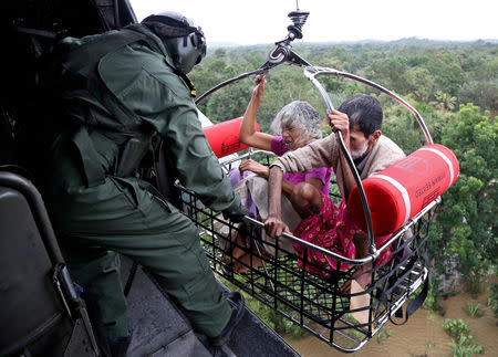 People are airlifted by the Indian Navy soldiers during a rescue operation at a flooded area in Kerala, August 18, 2018. REUTERS/Sivaram V/Files