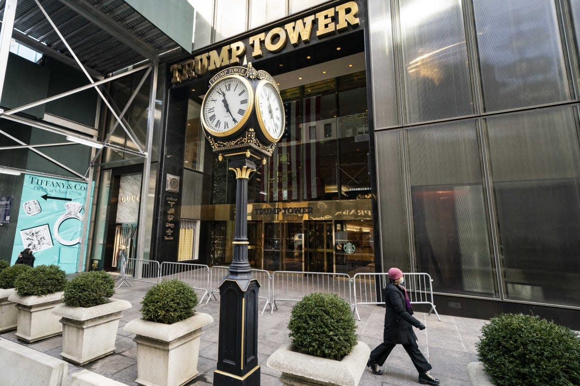 FILE — A pedestrian passes security barricades in front of Trump Tower, Feb. 17, 2021, in New York. Democrats in Congress have released six years’ worth of former President Donald Trump’s tax returns. It’s the culmination of a yearslong effort to learn about the finances of a onetime business mogul who broke decades of political norms when he refused to voluntarily release the information as he sought the White House. (AP Photo/John Minchillo, File)