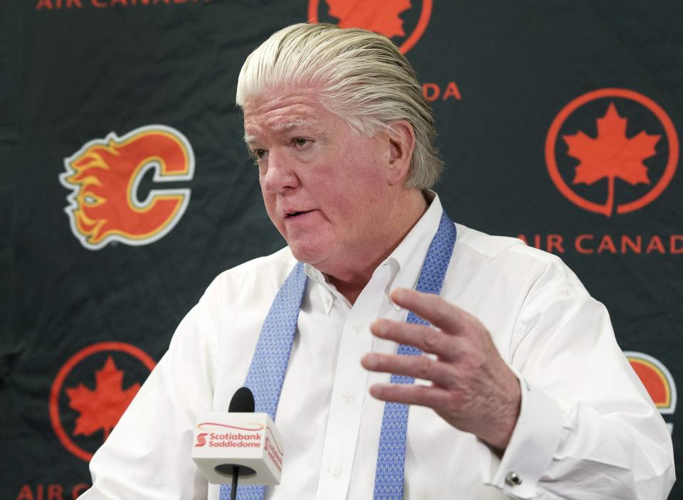 FILE - In this April 14, 2014, file photo, then-Calgary Flames' President of Hockey Operations and acting General manager Brian Burke speaks to the media in Calgary, Alberta. The uncertainty raised by coronavirus pandemic leads to experts providing a bleak short-term assessment on the NHL's financial bottom line, with some projecting revenues being cut by almost half. Former NHL executive-turned-broadcaster Brian Burke said the pain will be felt by teams and players alike. (AP Photo/The Canadian Press, Larry MacDougal, File)