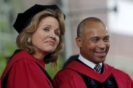 Soprano Renee Fleming (L) and former Massachusetts Governor Deval Patrick watch as graduating students arrive for the 364th Commencement Exercises at Harvard University in Cambridge, Massachusetts May 28, 2015. REUTERS/Brian Snyder