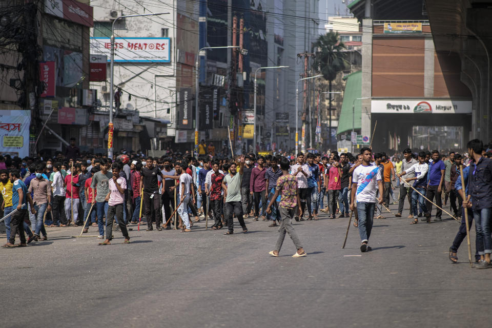 Bangladeshi garment workers block traffic during a protest demanding an increase in their wages at Mirpur in Dhaka, Bangladesh, Tuesday, Oct.31, 2023. (AP Photo/Mahmud Hossain Opu)