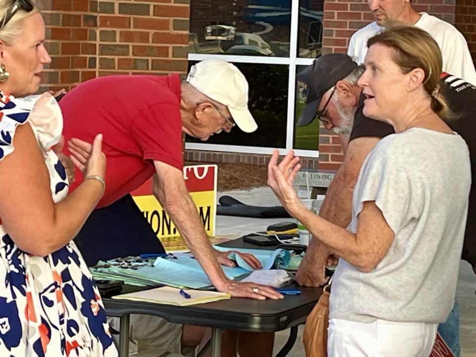 Volunteers gather petitions outside South Bulloch High School calling for a referendum to overturn local agreements that would allow the construction of four new water wells for Hyundai Motor Company's manufacturing facility near Savannah.