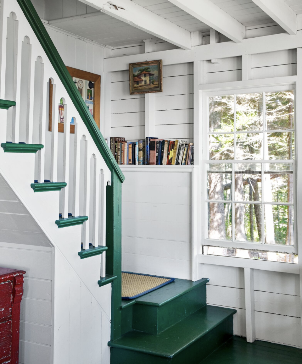 stairwell with green steps and a collection of books