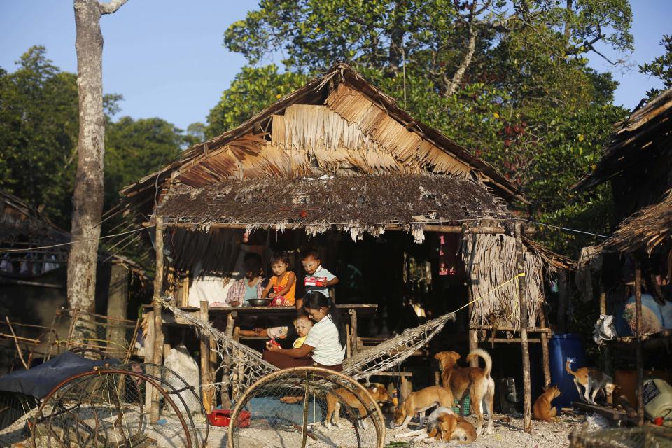 In this Feb. 11, 2014 photo, a Myanmarese fishermen family has breakfast outside their hut in Ma Kyone Galet village, inhabited by Moken and Myanmarese fishermen, on Bocho Island in Mergui Archipelago, Myanmar. The Moken, the sea nomads who have inhabited the Mergui archipelago for centuries, would make ideal nature guides.(AP Photo/Altaf Qadri)