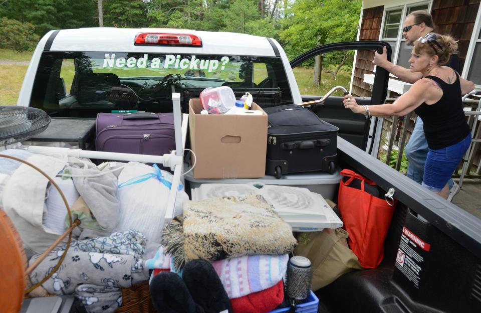 Alessandra Dabliz helps her brother George Paznola, who has stage 4 kidney cancer and is blind, into a rental truck filled with their belongings at 51 Dunns Pond Road in Hyannis. They were evicted following a court proceeding.