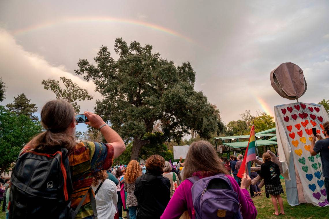 A rainbow forms in the sky above a Yolo is for Everyone rally in Davis Central Park on Tuesday, Oct. 10, 2023, as people stand in unitiy in the wake of recent bomb threats made at Davis-area schools and the city’s main library containing anti-LGBTQ language.