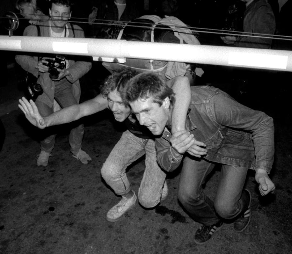 East Germans pass across the border between Hungary and Austria in Hegyeshalom on 11 September 1989.