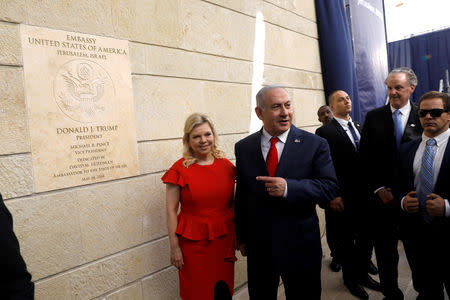 FILE PHOTO: Israeli Prime Minister Benjamin Netanyahu and his wife Sara Netanyahu stand next to the dedication plaque of the U.S. embassy in Jerusalem, after the dedication ceremony of the new U.S. embassy in Jerusalem, May 14, 2018. REUTERS/Ronen Zvulun/File Photo